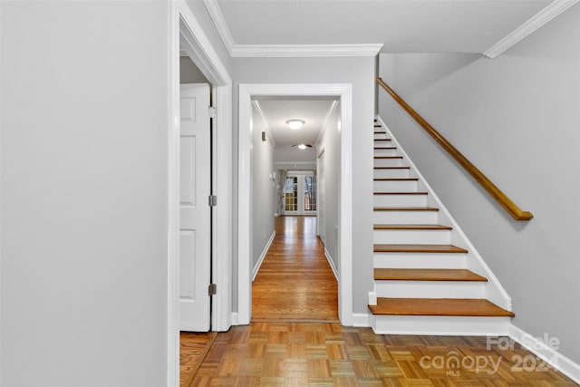 stairway with parquet floors and ornamental molding