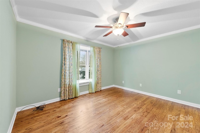 empty room featuring ceiling fan, light hardwood / wood-style floors, and ornamental molding