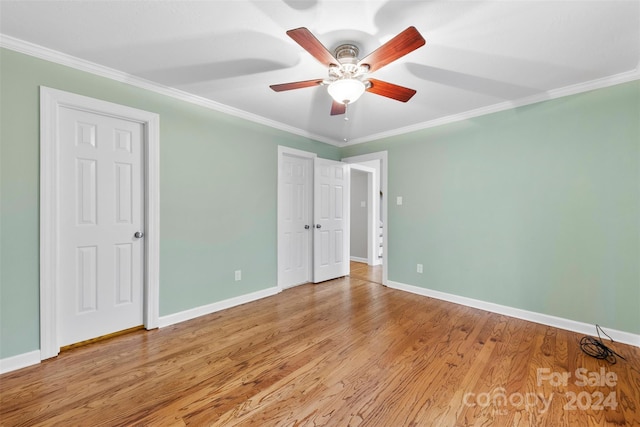 spare room featuring light hardwood / wood-style floors, ceiling fan, and crown molding