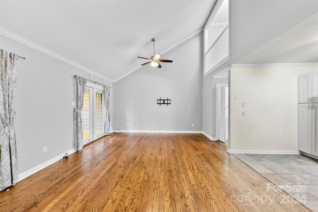 unfurnished living room with high vaulted ceiling, french doors, crown molding, ceiling fan, and light wood-type flooring