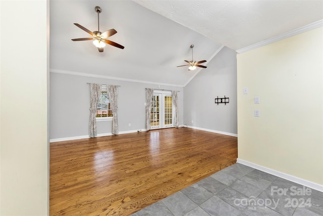 spare room featuring ceiling fan, wood-type flooring, ornamental molding, and vaulted ceiling