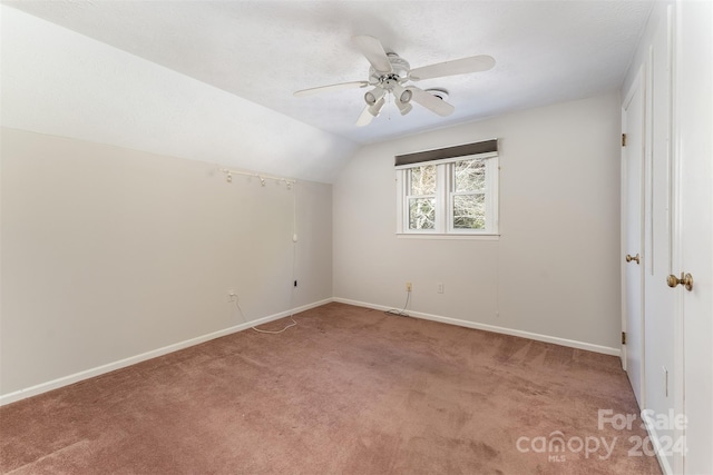 additional living space featuring light carpet, vaulted ceiling, and ceiling fan