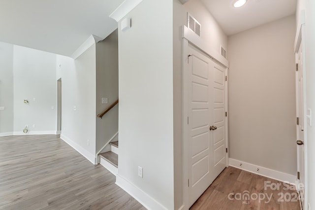 corridor with light hardwood / wood-style floors