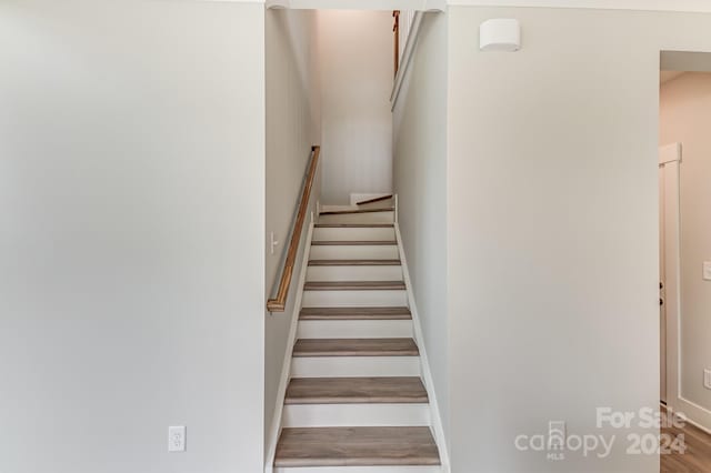 stairs featuring wood-type flooring