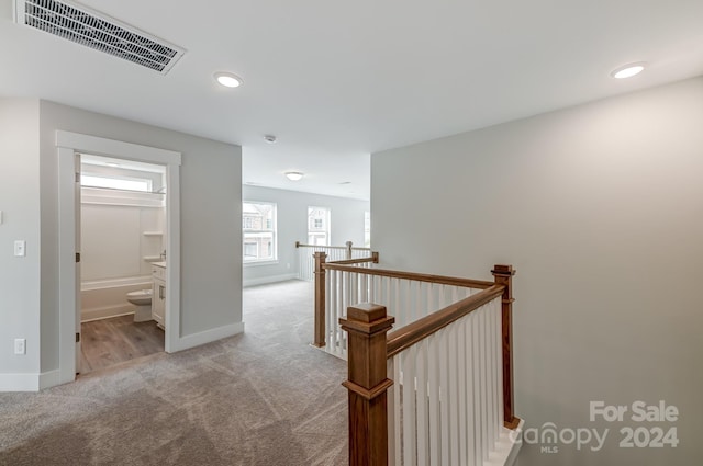 hallway with light carpet