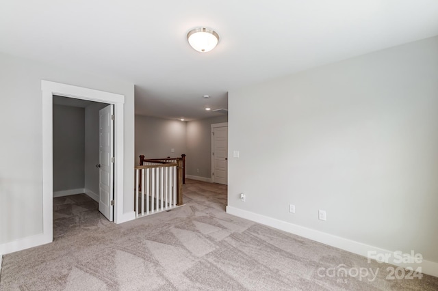 empty room featuring light colored carpet