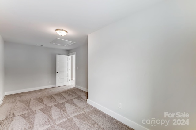 unfurnished room with light carpet