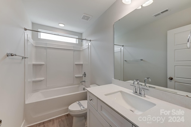 full bathroom with hardwood / wood-style floors, vanity,  shower combination, and toilet