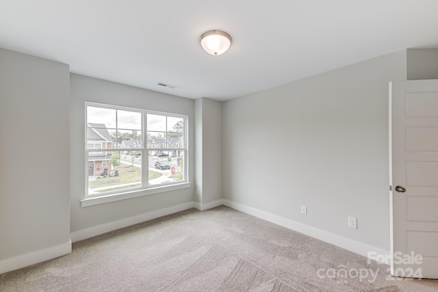 empty room with light colored carpet