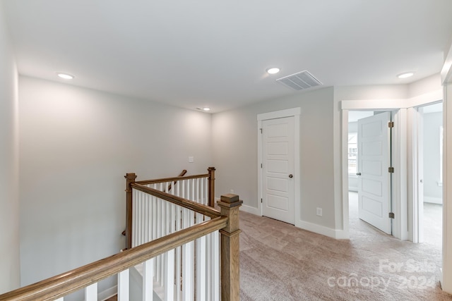 corridor with light colored carpet