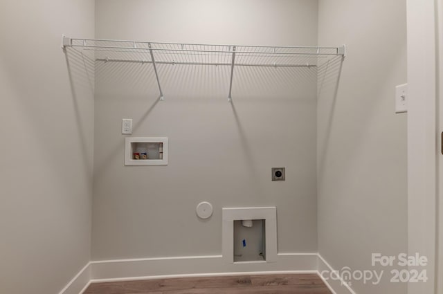 washroom featuring hookup for an electric dryer, hardwood / wood-style flooring, gas dryer hookup, and hookup for a washing machine