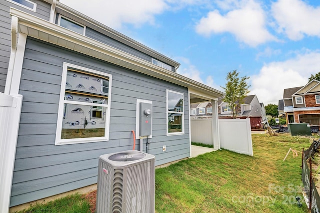 exterior space with a lawn and central air condition unit