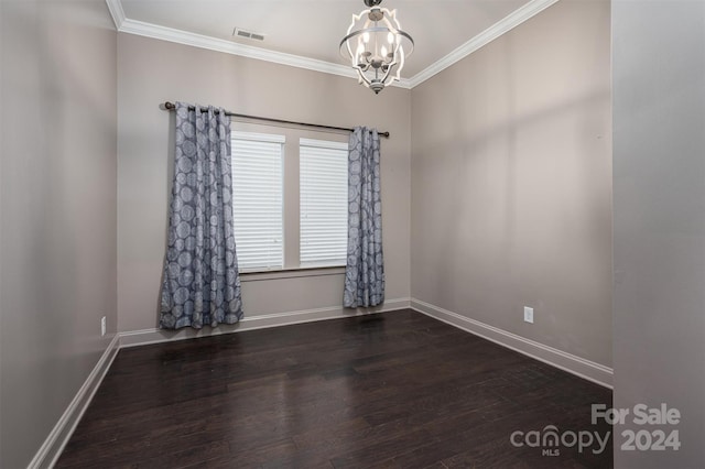 unfurnished room featuring a notable chandelier, dark hardwood / wood-style floors, and crown molding