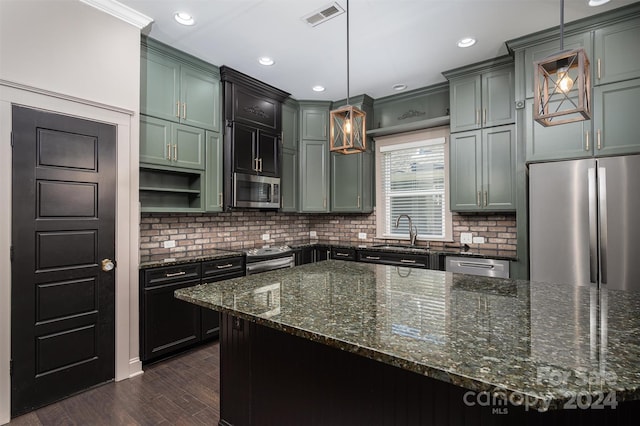 kitchen featuring tasteful backsplash, dark hardwood / wood-style floors, stainless steel appliances, and decorative light fixtures