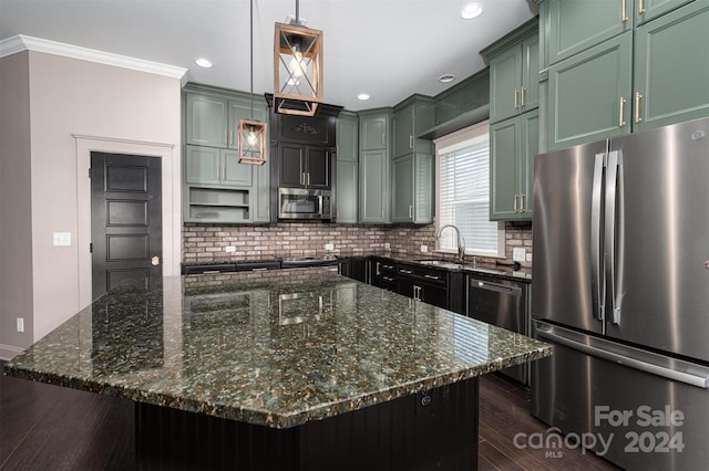 kitchen featuring a center island, hanging light fixtures, stainless steel appliances, dark stone counters, and ornamental molding