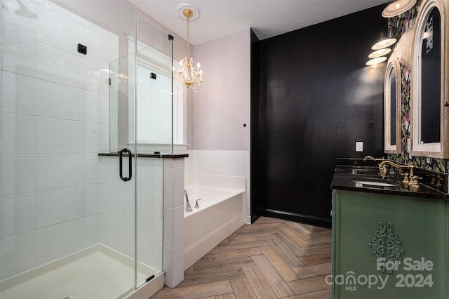 bathroom with parquet flooring, an inviting chandelier, vanity, and shower with separate bathtub