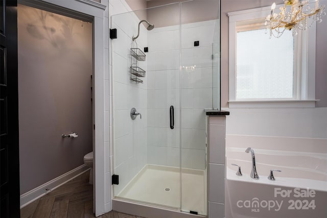 bathroom featuring separate shower and tub, toilet, parquet floors, and a chandelier