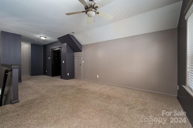 bonus room with ceiling fan, lofted ceiling, and light carpet