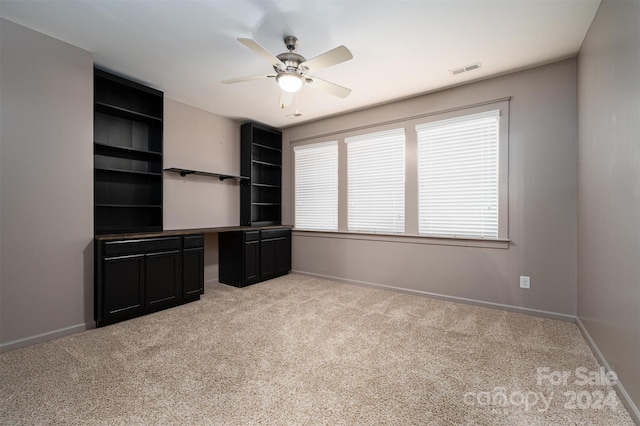 interior space with light carpet and ceiling fan