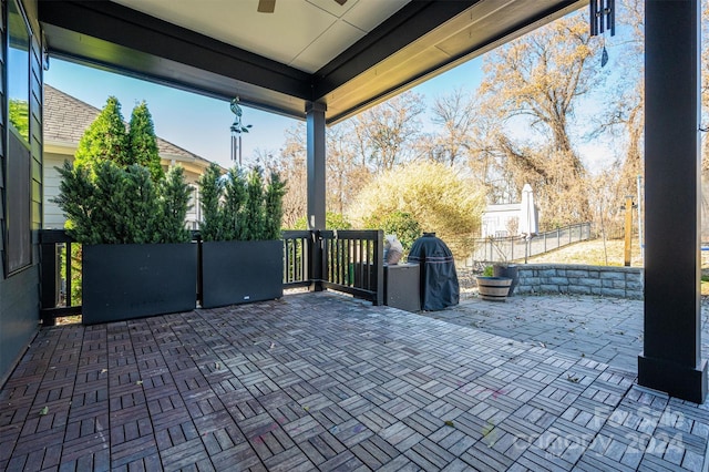 view of patio featuring area for grilling and ceiling fan