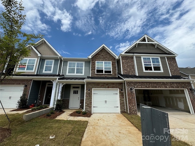 view of front of house with a garage and a front lawn