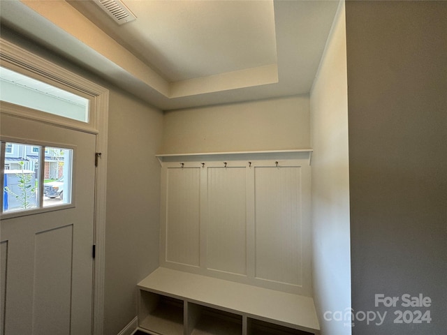 mudroom with a tray ceiling