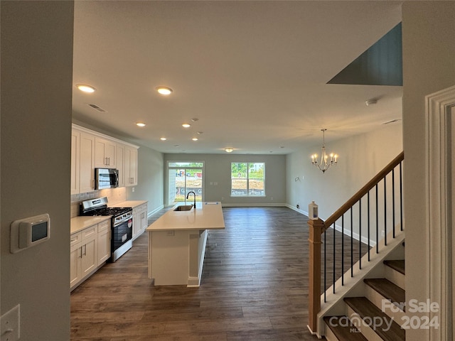 kitchen featuring sink, stainless steel appliances, dark hardwood / wood-style floors, an island with sink, and white cabinets