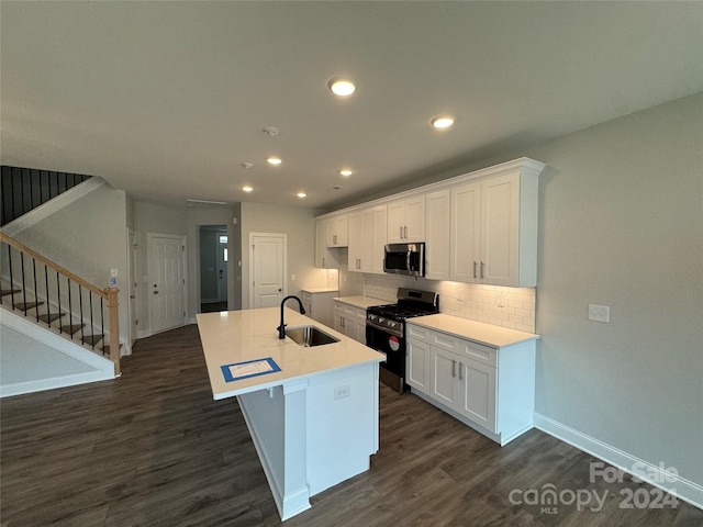 kitchen with dark wood-type flooring, sink, white cabinets, and stainless steel appliances