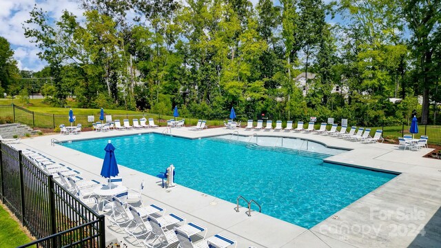 view of swimming pool with a patio area