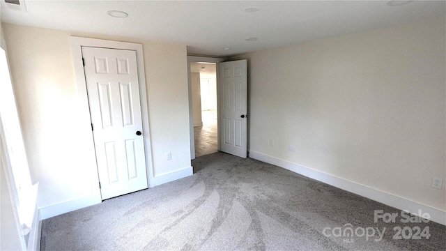 unfurnished bedroom with a closet and carpet