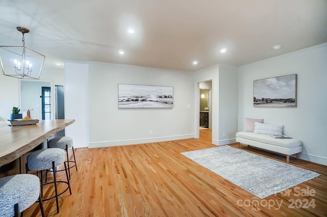 living room with light wood-type flooring and a chandelier