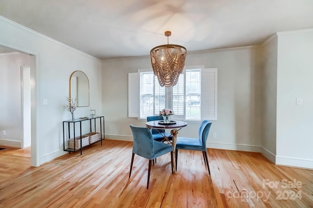 dining room with crown molding and light hardwood / wood-style floors