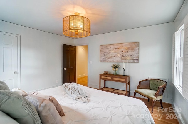 bedroom with wood-type flooring