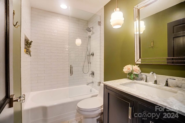 full bathroom featuring vanity, toilet, and tiled shower / bath