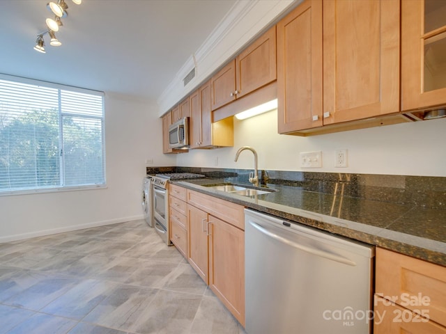 kitchen with visible vents, glass insert cabinets, appliances with stainless steel finishes, ornamental molding, and a sink