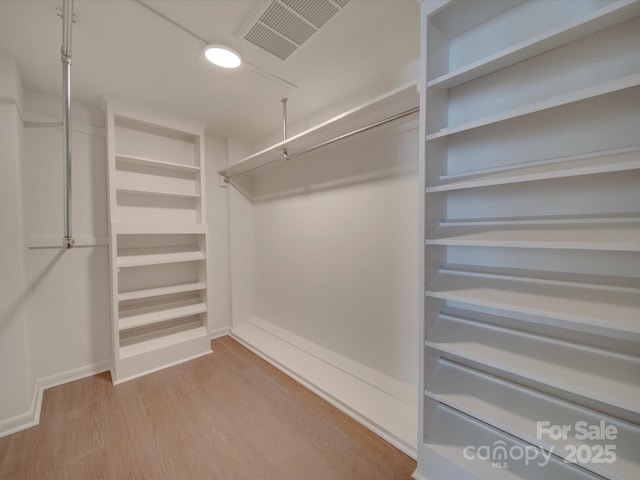 walk in closet featuring light wood-style floors and visible vents