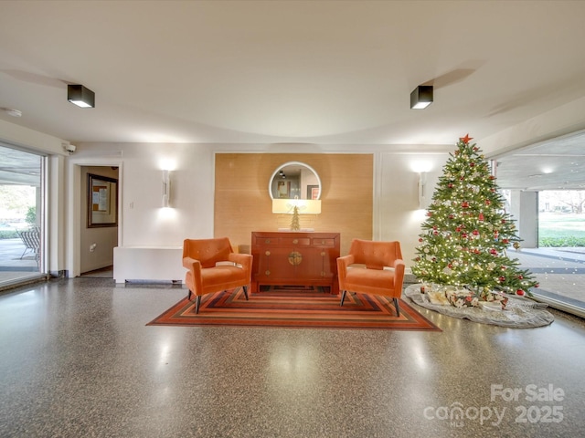 living area featuring speckled floor