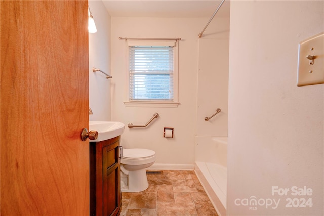 bathroom with a shower, vanity, and toilet