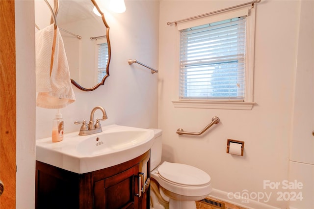 bathroom featuring vanity and toilet