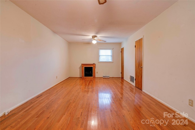 unfurnished living room featuring ceiling fan and light hardwood / wood-style flooring