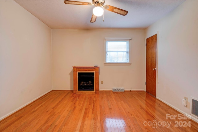 unfurnished living room with ceiling fan and light hardwood / wood-style floors