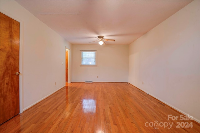 empty room featuring ceiling fan and light hardwood / wood-style flooring