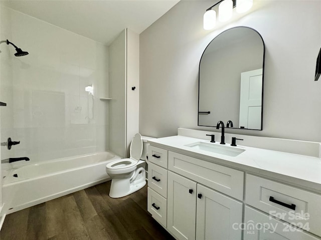 full bathroom with toilet, vanity, hardwood / wood-style flooring, and bathing tub / shower combination