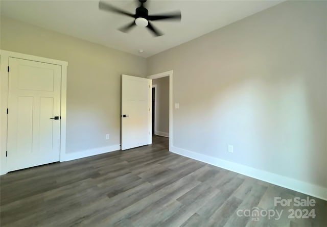 unfurnished bedroom with ceiling fan and wood-type flooring