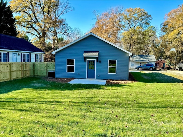 rear view of house with a lawn