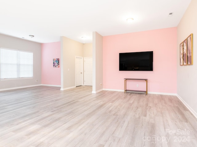 unfurnished living room featuring light wood-type flooring