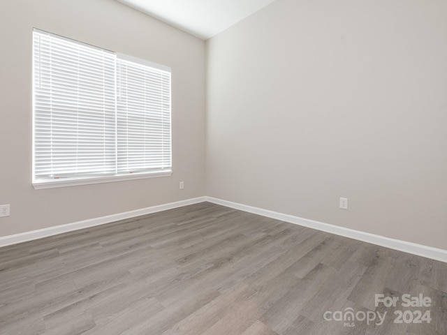 empty room with hardwood / wood-style floors