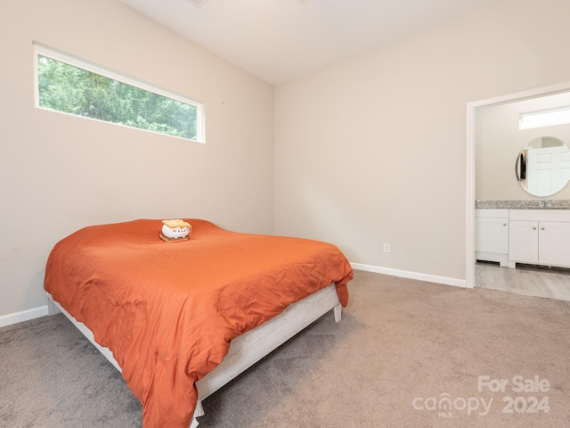 carpeted bedroom with ensuite bath