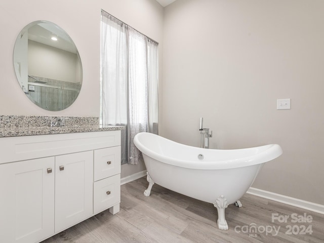 bathroom featuring hardwood / wood-style flooring, vanity, and independent shower and bath