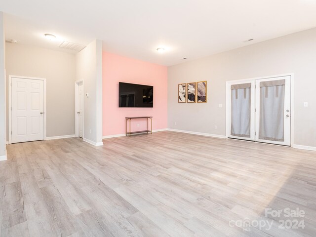 unfurnished living room with light wood-type flooring